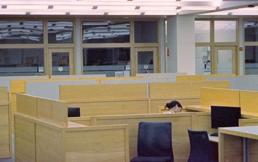 Modern open office workspace with computers and natural light