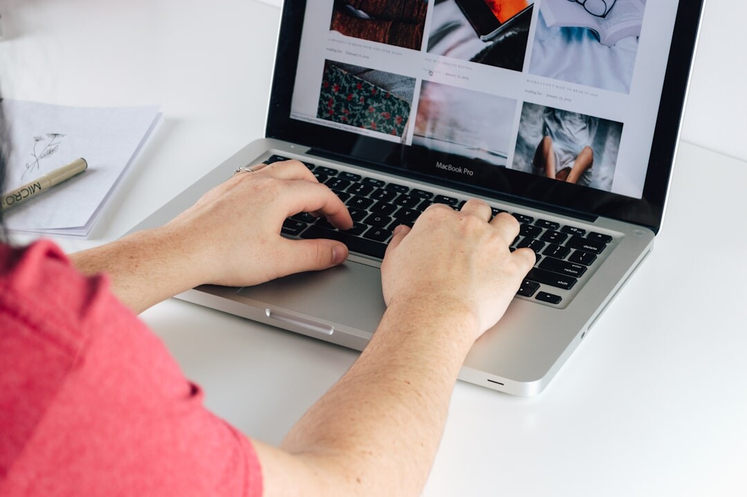 Journalist writing news story on laptop